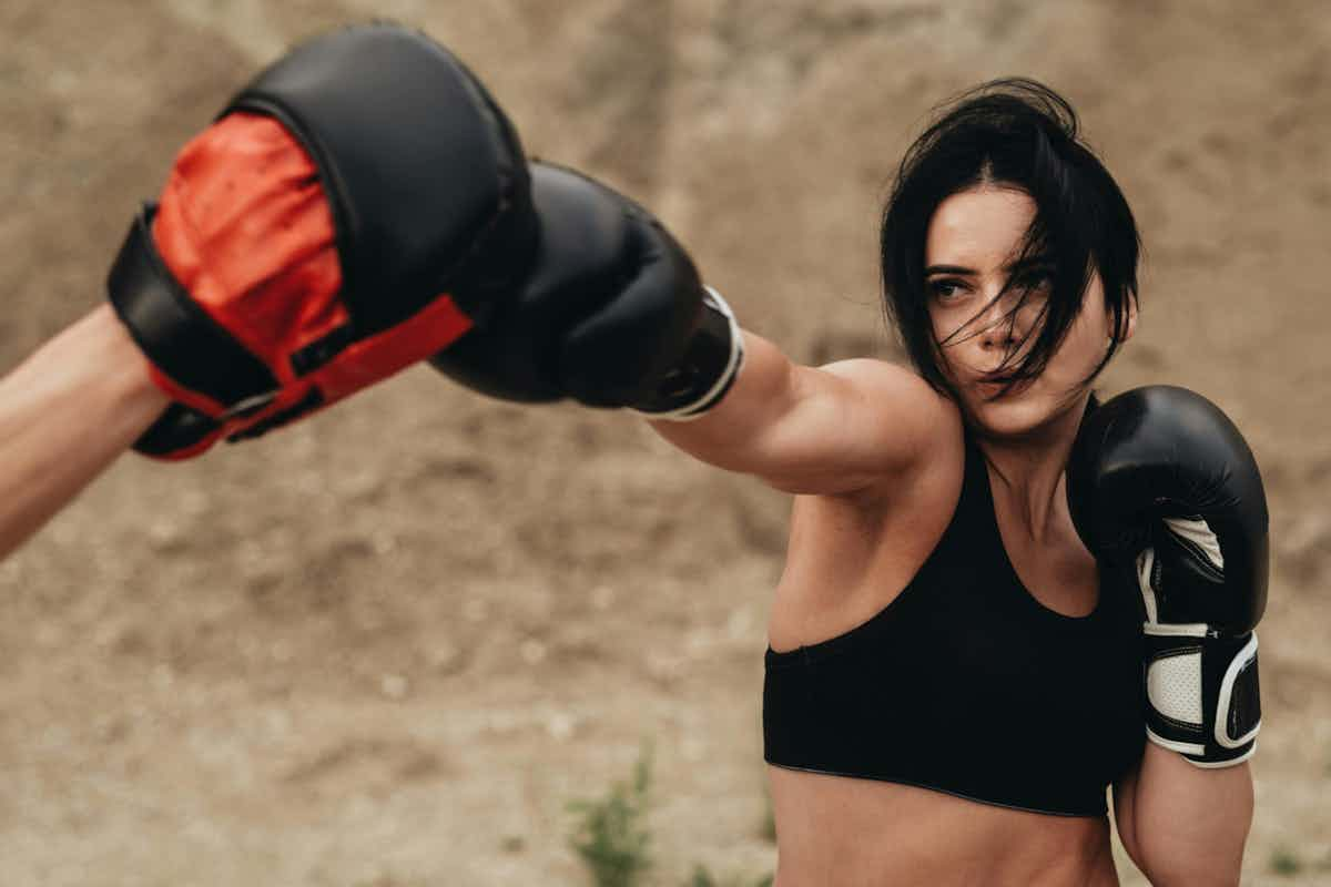 woman practicing at a kickboxing class